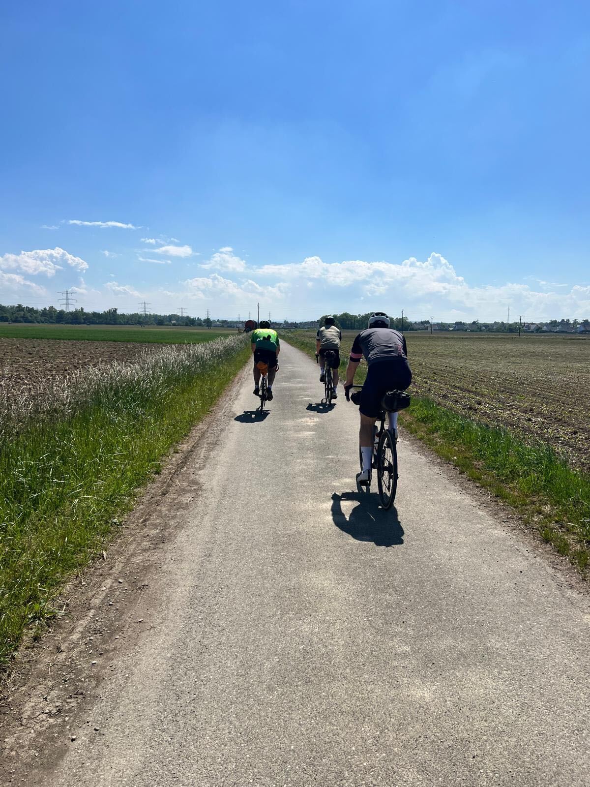 Riders heading across the open Rhine plain under blue skies