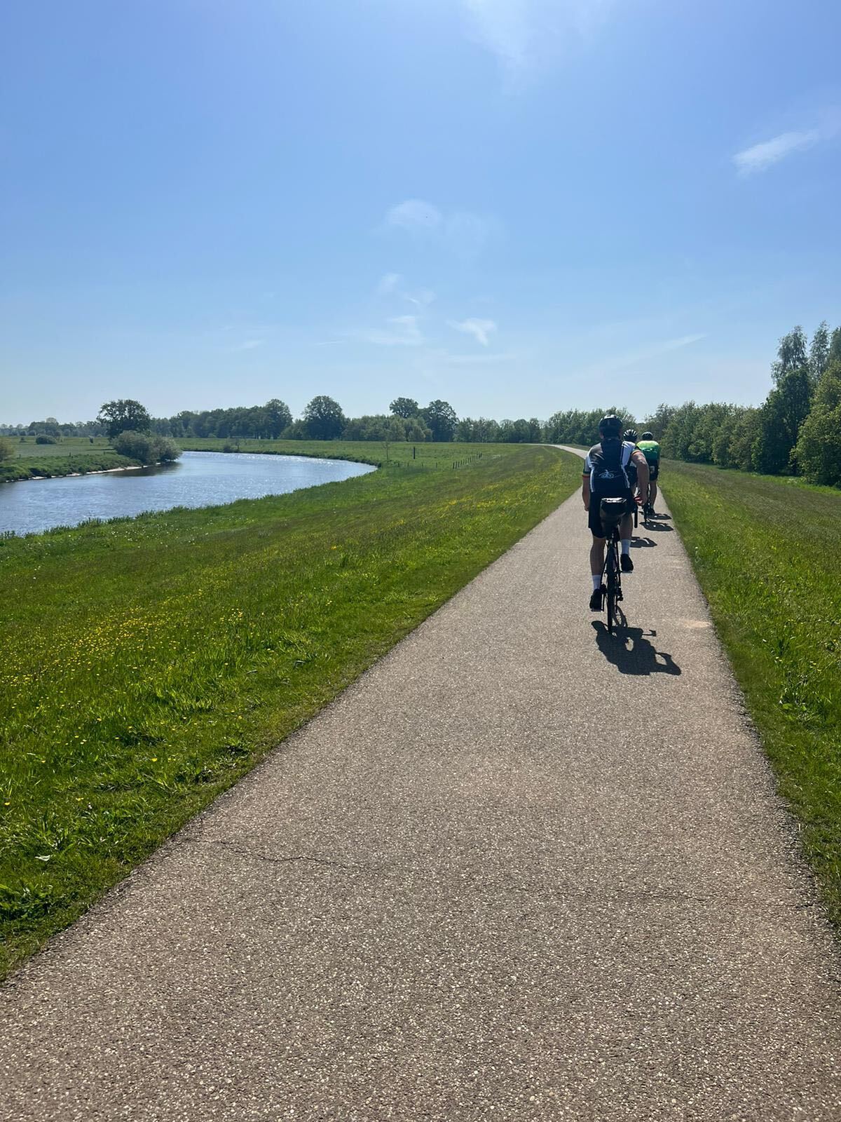 Cyclists on a Dutch polder cycle path on the Amsterdam to Hamburg cycling route